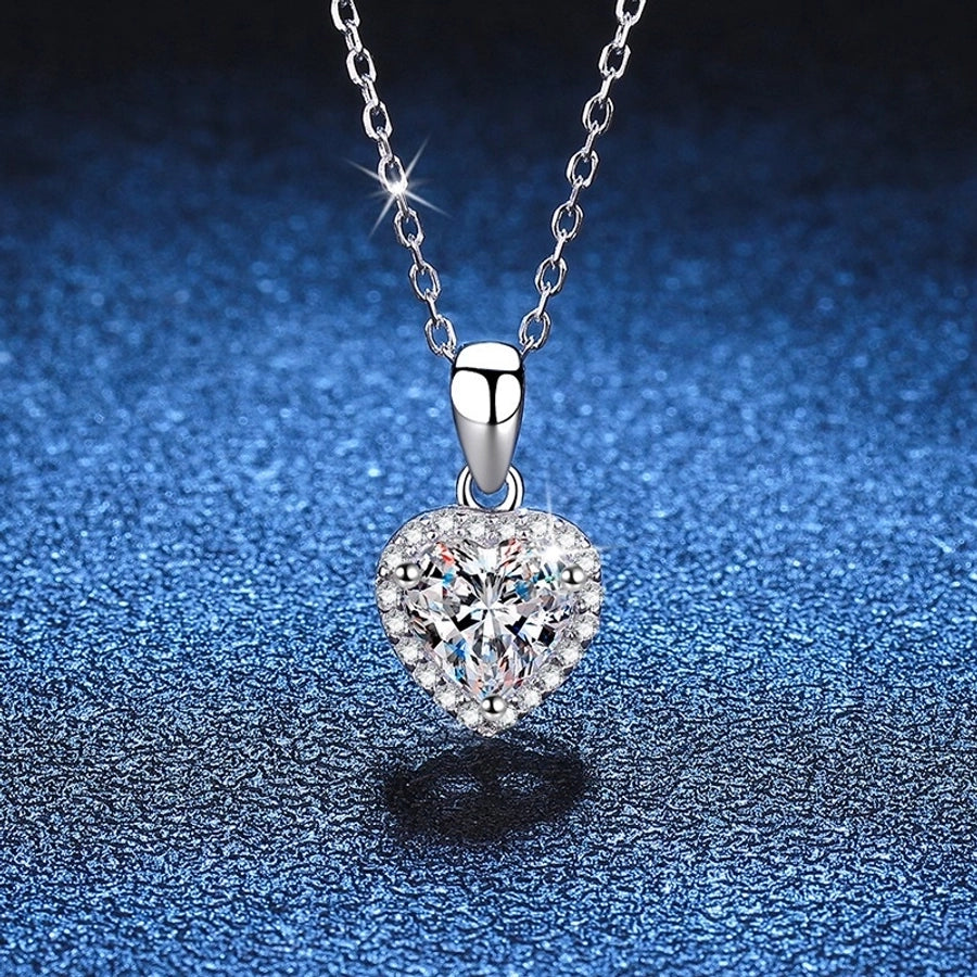 Moissanite diamond heart pendant necklace in sterling silver.