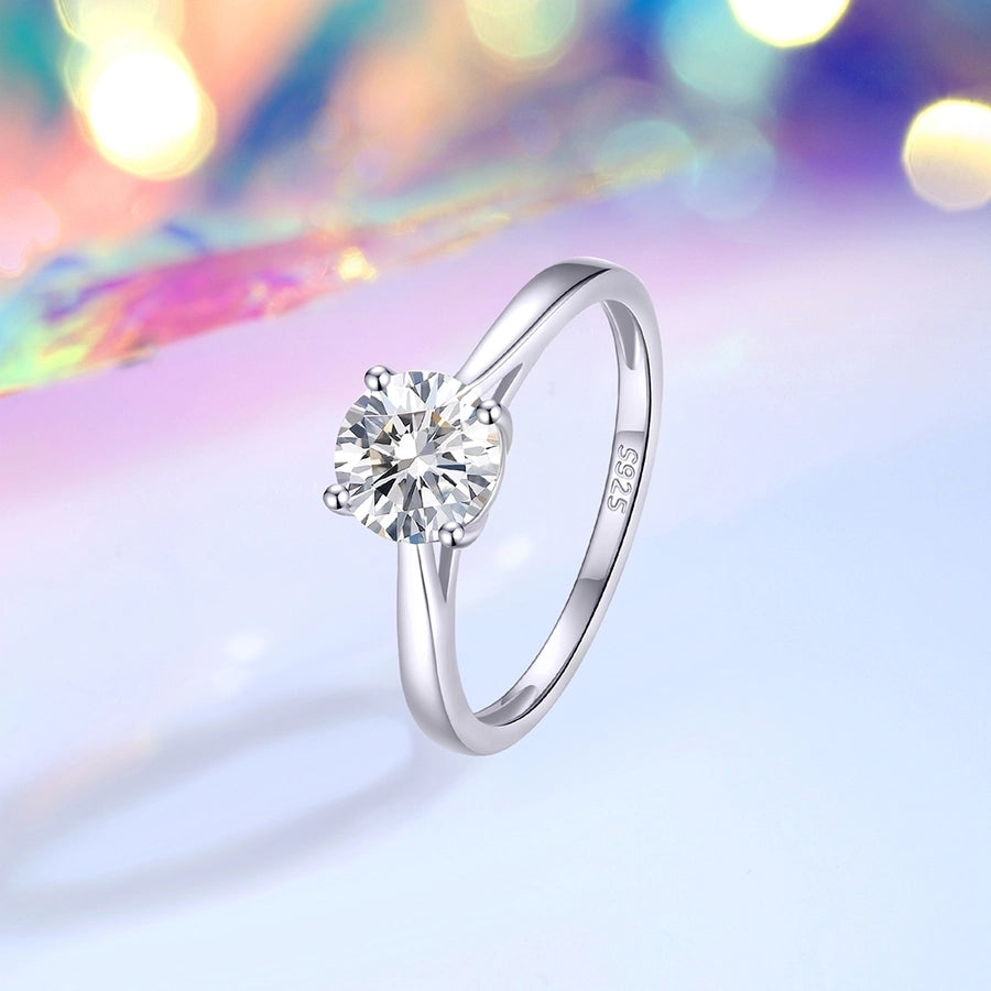 Elegant moissanite solitaire ring in polished sterling silver setting.