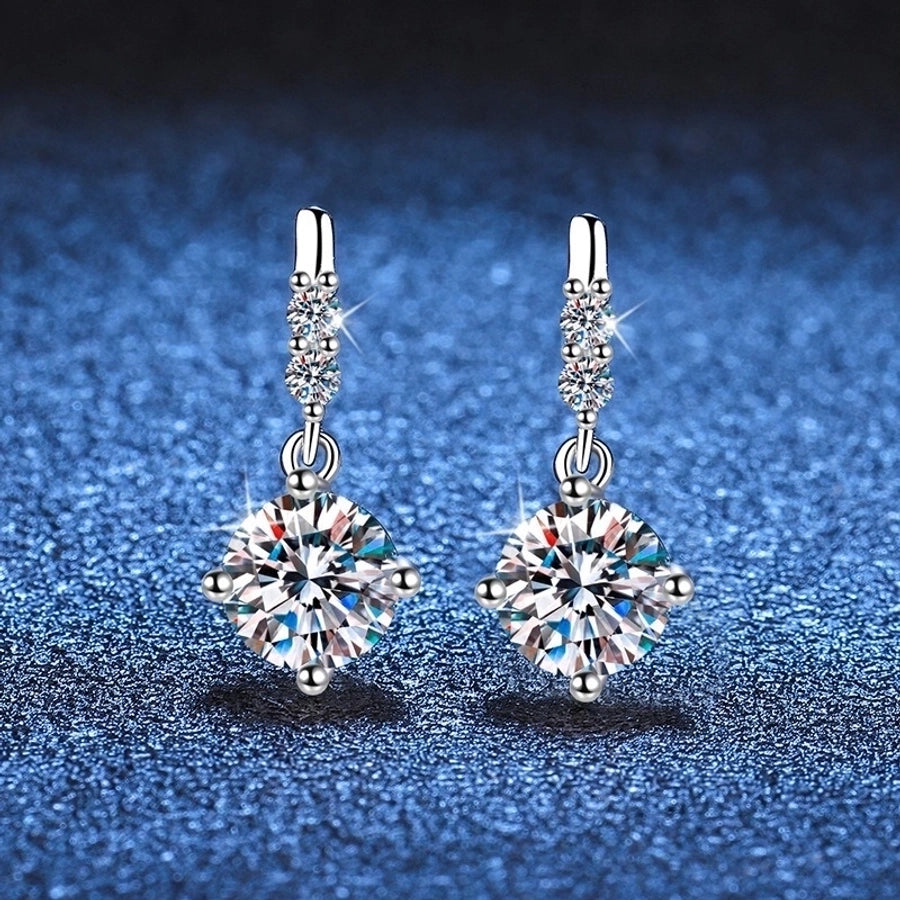 Sterling silver earrings featuring brilliant moissanite & diamonds. Timeless sparkle.