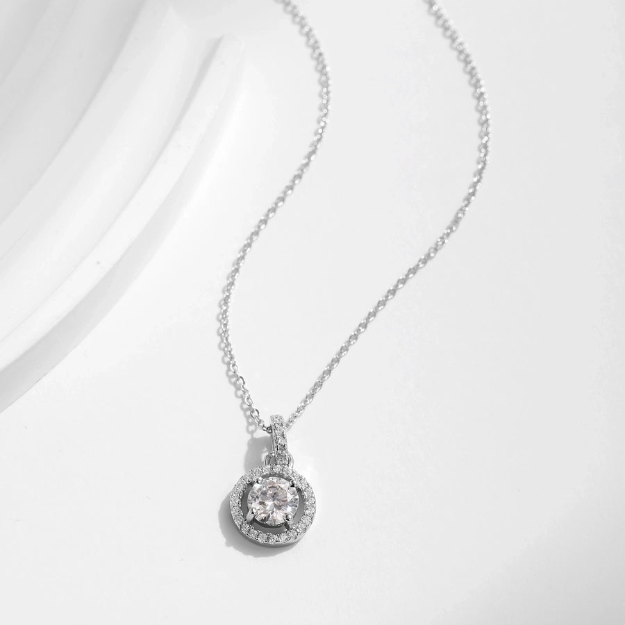 Halo diamond pendant on silver chain, brilliant moissanite center.