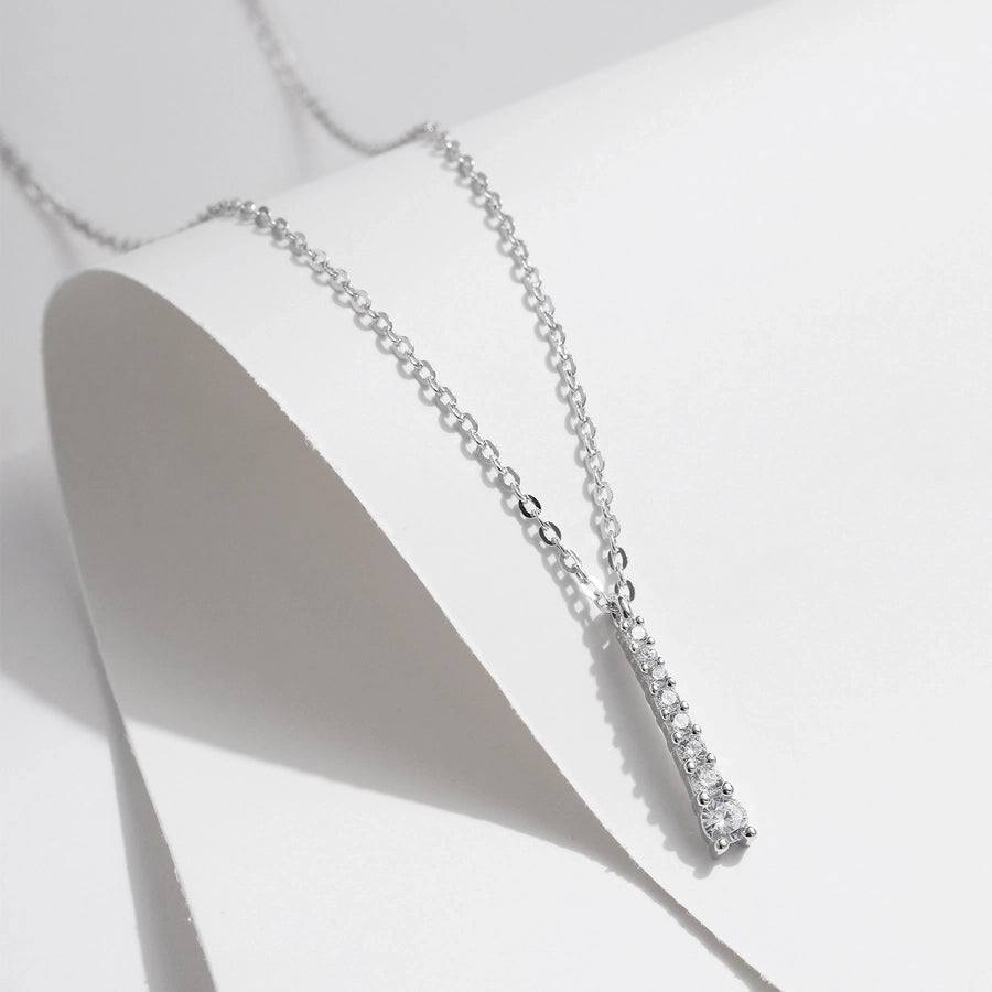 Vertical bar necklace, moissanite stones, set in sleek sterling silver.