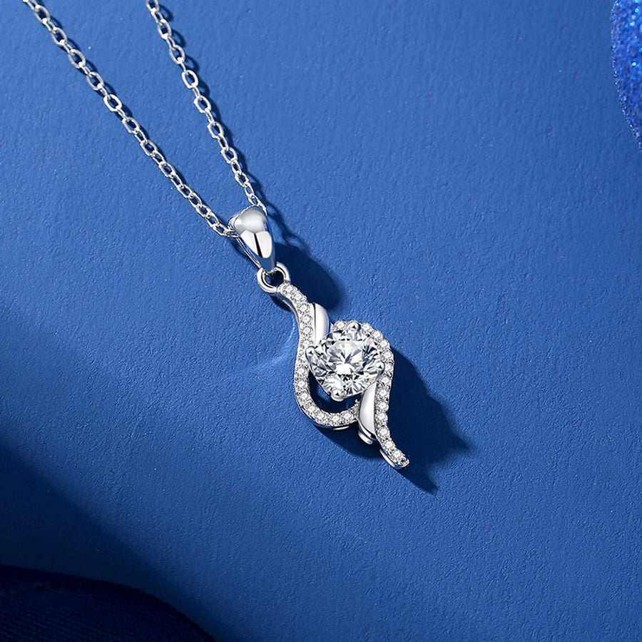 Sparkling moissanite pendant on a silver chain.