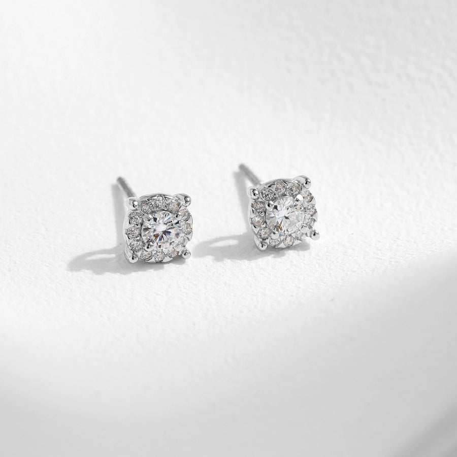 Classic stud earrings, sterling silver, featuring luminous moissanite & diamonds.