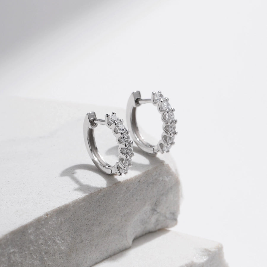 Sparkle with these sterling silver hoop earrings, adorned with moissanite.