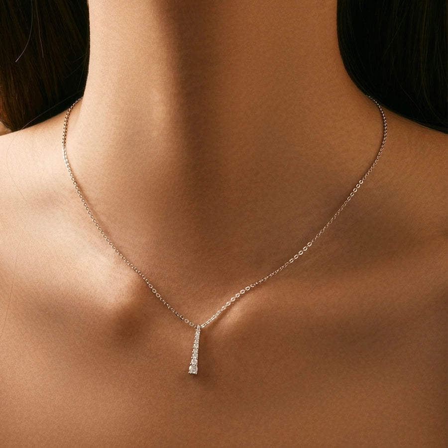 Modern minimalist necklace, sterling silver, featuring bright moissanite gems.