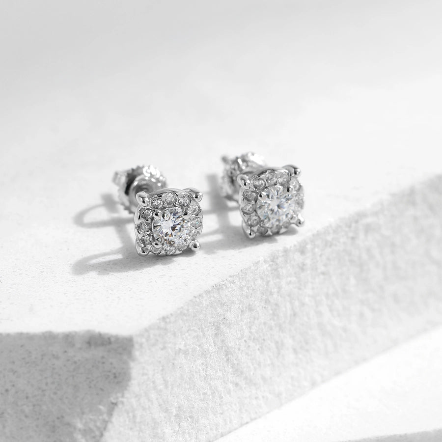 Chic sterling silver earrings with brilliant moissanite centers & diamond halos.