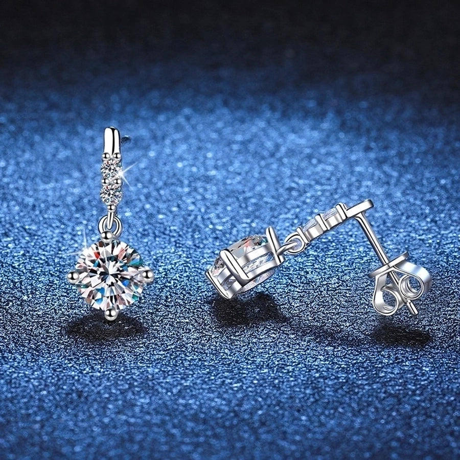 Moissanite and diamond earrings set in polished sterling silver. Fine jewelry design.