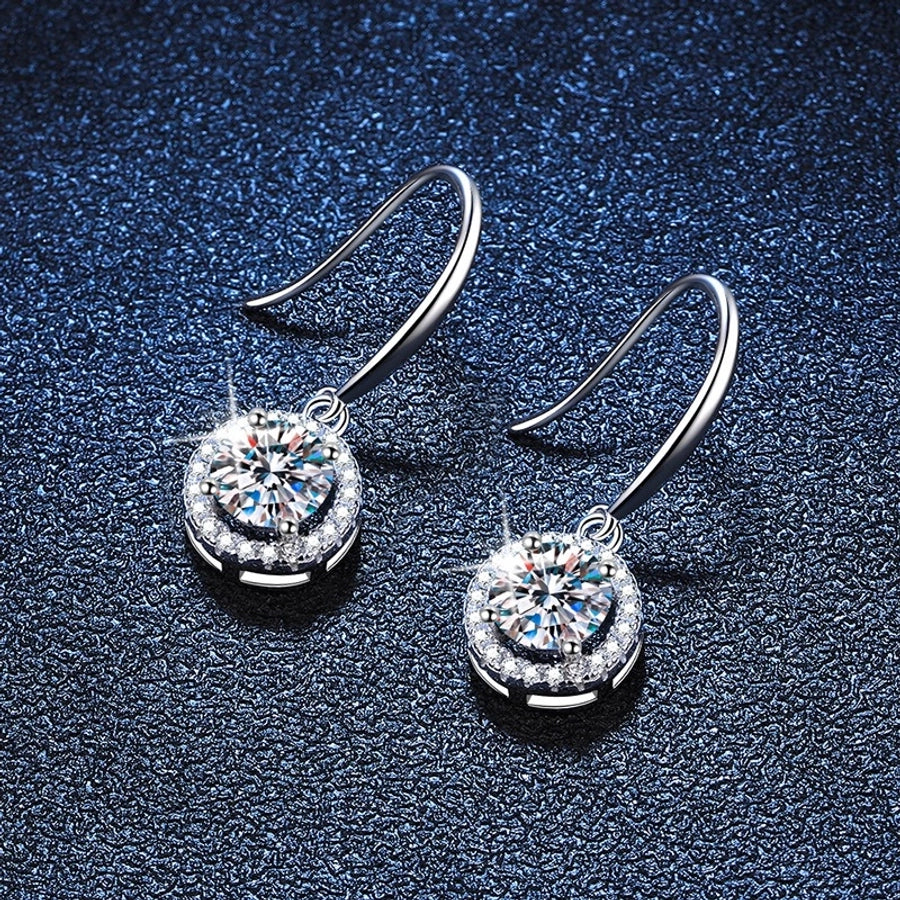 Dazzling moissanite and diamond earrings in sterling silver, prong setting.